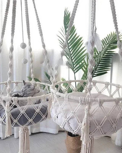 Cat hammock hanging bed with handwoven boho design and cotton mat for lounging and playing.