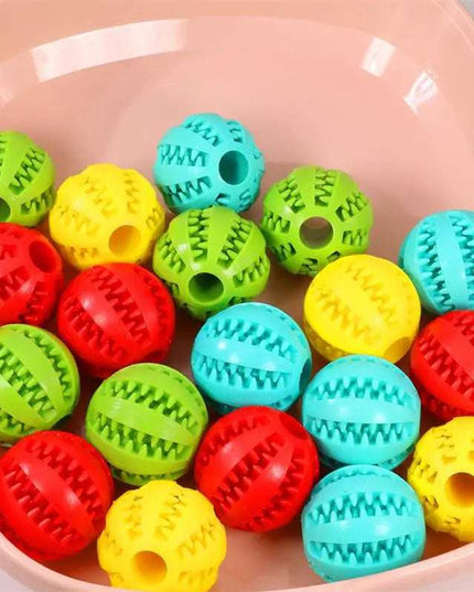 Interactive rubber dog food balls in various colors for playful pets.
