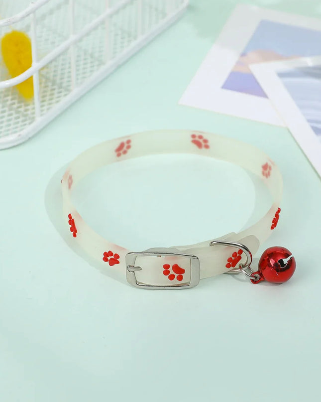 Luminous Cat Necklace Glowing Collar with Red Paw Prints and Bell on Mint Background